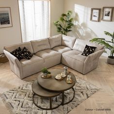 a living room with a sectional couch and coffee table