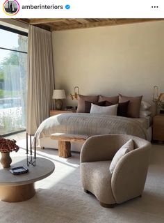 a large bed sitting next to a window in a bedroom