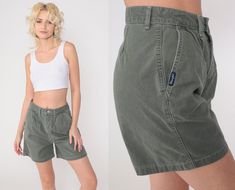 Vintage 90s shorts by Wrangler in olive green with pleating and a high waist. Please see measurements and condition below. Every garment we sell is authentic vintage! You will receive the exact item photographed. Condition: Very good vintage with light general wear. Best fits women's: Labelled size 6 Tag: Wrangler Material:  Feels like Cotton MEASUREMENTS Taken from seam to seam while the garment is lying flat. Double the armpit, waist, and hips For reference, model is 5'7" and measures 31-24-35 Cheap Green Shorts With Short Inseam, Green Shorts Outfit, Thrift Ideas, Retro Trousers, Trouser Shorts, 90s Shorts, Outfit 90s, Bermuda Short, Pleated Shorts