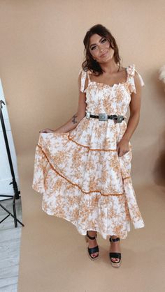 The midi of your boho dreams. Our Wanderlust Lace Trim Floral Midi features a slimming smocked bust, adjustable bow style straps, a tiered design & a dainty floral design throughout. Adjustable bow straps Functional side pockets Lined Smocked bust 100% Cotton; Lining: 100% Polyester Imported Fit: Relaxed; true to size Measurements: S - 29" Bust, 25" Waist, 50" Hips, 42" Length M - 31" Bust, 27" Waist, 52" Hips, 43" Length L - 33" Bust, 29" Waist, 54" Hips, 44" Length Model Specs: Karli + Emily a Everyday Chic, Chic Boutique, Floral Midi Dress, Smocking, Lace Trim, Trim, Floral Design, Midi Dress, Boutique