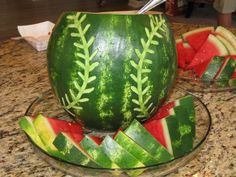 a watermelon bowl filled with pieces of fruit