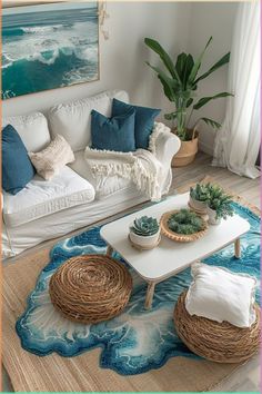 a living room filled with white furniture and lots of blue pillows on top of it