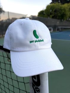 "The perfect gift for a pickle ball champ or any pickle lover.  * 100% chino cotton twill * Unstructured, 6-panel, low-profile * 6 embroidered eyelets * 3 ⅛\" (7.6 cm) crown * Adjustable strap with antique buckle This product is made especially for you as soon as you place an order, which is why it takes us a bit longer to deliver it to you.  RETURNS AND EXCHANGES * All sales are final unless the item arrives damaged * If your item arrives damaged, please contact us within 28 days of receiving Cotton Dad Hat With Letter Embroidery For Baseball Season, White Cotton Dad Hat With Letter Embroidery, White Cotton Hats With Custom Embroidery, White Embroidered Cotton Dad Hat, Novelty Cotton Adjustable Baseball Cap, Novelty Cotton Baseball Cap One Size, Novelty Cotton Baseball Cap One Size Fits Most, Embroidered Cotton Baseball Hat, Custom Embroidered Cotton Dad Hat