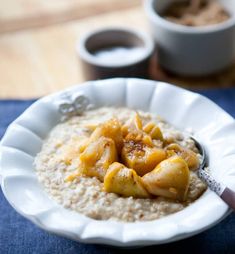 a white bowl filled with oatmeal on top of a blue table cloth