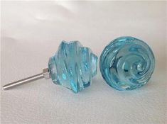 two blue glass knobs sitting next to each other