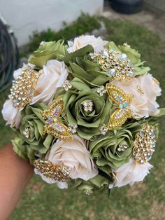 a bridal bouquet with brooches and flowers