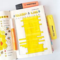 an open notebook with drawings and markers on it