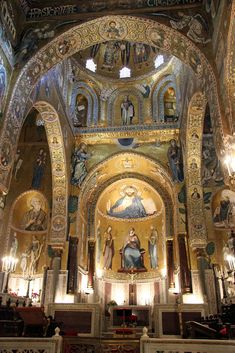 the interior of an ornate church with paintings on the walls