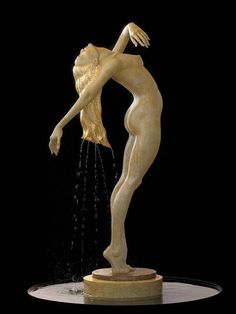 a statue is shown with water coming out of it's body and hands in the air