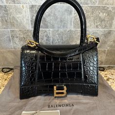 Balenciaga Black Hours Croco With Tags Includes Dustbag Designer Handheld Bags With Gold-tone Hardware, Designer Flap Bag With Top Handle For Shopping, Designer Top Handle Flap Bag For Shopping, Designer Satchel Evening Bag With Top Carry Handle, Designer Tote Flap Bag With Branded Hardware, High-end Flap Bag With Branded Hardware For Shopping, Designer Evening Bag With Detachable Strap For Shopping, Designer Handheld Box Bag With Gold-tone Hardware, Designer Handheld Bag With Branded Hardware