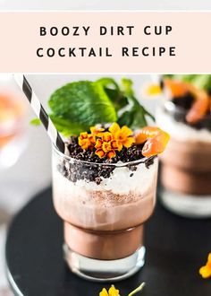 boozy dirt cup cocktail recipe with flowers and mints in the bottom, on a black plate