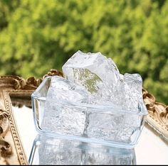 ice cubes in a glass container on a table