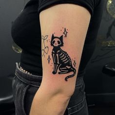 a woman with a cat tattoo on her arm