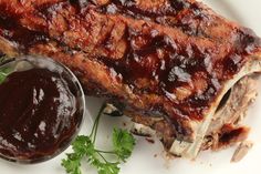 the ribs are covered in barbecue sauce and garnished with parsley