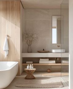 a white bath tub sitting next to a bathroom sink