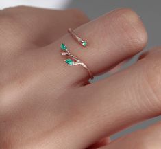 Shop our beautiful Original 925 Silver two green Ivy Olive Shaped Leaf Ring on Etsy. This dainty and elegant ring is handmade with love and care, featuring a unique olive tree design. Wear it as a symbol of protection against the evil eye, or simply as a stylish accessory for everyday wear. This stackable ring makes a perfect gift for birthdays, Christmas, or for your best friend. Invest in your beauty and add this handmade leaf design tree branch ring to your jewelry collection today! Find the perfect gift for your loved one with our minimalist heart shape infinity necklace. This elegant piece of jewelry is a symbol of eternal love and makes a great Valentine's Day or anniversary present. Add a touch of romance to your outfit with this beautiful necklace, handmade with care and attention Green Dainty Jewelry For Promise, Nature-inspired Ring With May Birthstone For Gift, Nature-inspired Emerald Ring For May Birthstone Gift, Gift Nature-inspired Emerald Ring For May Birthstone, Dainty Green Birthstone Open Ring, Fine Jewelry Flower Ring For May Birthstone, Elegant Green Sterling Silver Flower Ring, Elegant Green Flower Ring In Sterling Silver, Delicate Green Rings For Promise