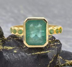 Genuine Zambian Emerald Ring - 14k Gold Solitaire Emerald Ring - Bezel Set Emerald Yellow Gold Ring - With Certified Emerald Ring  GEMSTONE DETAILS : ✦ Gemstone : Natural Colombian Emerald ✦ Gemstone Size : 8x11 mm ✦ Gemstone Shape : Emerald Cut ✦ Number of Gemstones : 1 ✦ Gemstone Weight : 4.50 Carat ✦ Gemstone Grade : AAA SMALL EMERALD DETAILS : ✦ Emerald Type : Natural ✦ Emerald Size : 3.5 MM ✦ Emerald Color : Vivid ✦ Emerald Clarity : Slightly included ✦ Emerald Cut : Excellent ✦ Emerald Wei Yellow Gold Emerald Ring With Bezel Setting For Anniversary, Anniversary Emerald Ring In Yellow Gold With Bezel Setting, 14k Gold Jewelry With Fluted Bezel For Gift, Fine Jewelry With Fluted Bezel In 14k Gold, Unique Green Emerald Ring With Bezel Setting, Fine Jewelry Yellow Gold Emerald Ring With Bezel Setting, Fine Jewelry Ring With Fluted Bezel, Luxury 14k Gold Emerald Ring With Bezel Setting, Yellow Gold Emerald Ring With Smooth Bezel