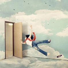 a person jumping in the air from an open door to another room with clouds and birds