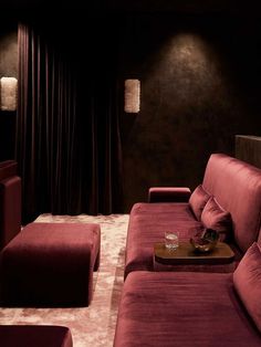 a living room with red couches and pillows