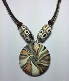 a necklace with an abstract design on it