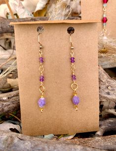 Material info: Gemstone dangle earrings Gemstone beads: Amethyst Tiny Faceted Saucer 3x4mm, Lepidolite Faceted Rice 8x6.5-7mm Wire: Tarnish resistant. 22-gauge gold copper Jump rings: 18k gold plated Lepidolite properties: "peace stone" or "grandmother stone" because it is thought to have nurturing and calming properties. Amethyst properties: Known for promoting calm, clarity, and spiritual development. All jewelry is uniquely handmade to order. Handmade Purple Jewelry In 14k Gold Filled, Dainty Gold Amethyst Earrings, Gold Amethyst Dainty Earrings, Gold Dangle Earrings With Gemstone Beads, Gold Drop Earrings With Gemstone Beads, Gold Gemstone Bead Drop Earrings, Gold Amethyst Earrings With Ear Wire, Handmade Purple 14k Gold Filled Jewelry, Hypoallergenic Amethyst Drop Earrings