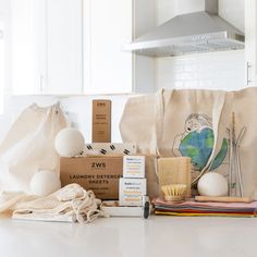 the contents of a personal care kit on a kitchen counter with a bag and other items