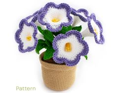 crocheted flowers in a pot on a white background