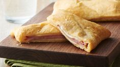 two pastries sitting on top of a wooden cutting board