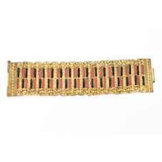 This is part of Chairish’s Costume Jewelry assortment.  This beautiful vintage Grecian cuff bracelet is a combination of red and black enamel set against gold plated metal with chain and link work. It is from the 50's. It is marked Made In Greece. There is a long pin that closes the bracelet into cuff form. There is some bead work on each panel. Great with even a simple white tee and jeans. This will be a stunning addition on your arm for day or evening wear. It is 2" H and 2" D closed up as a c Antique Gold Enamel Bracelets, Vintage Gold Enamel Bracelets, Formal Red Metal Bracelets, Retro Enamel Jewelry For Party, Retro Enamel Party Jewelry, Vintage Black Enamel Bracelet Jewelry, Vintage Black Enamel Bracelet, Antique Red Bracelet For Formal Occasions, Red Antique Bracelet For Formal Occasions