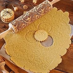 a wooden table topped with lots of different types of cookies and doughnuts on top of it