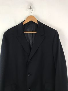 "-Description- >men's black wool overcoat >collared >three button front >two flap close pockets on the front >two buttons on the cuffs >lined >vent in the back >size large >perfect for a business coat! >condition: great >color(s): black >fabric(s): wool >brand: hymans clothes >care: dry clean -Measurements- >size: large ✩ all measurements are taken with the item laying flat & some sizes are estimates so please check measurements ✩ chest: 48\" / 12 Formal Black Single Breasted Wool Coat, Formal Black Single-breasted Wool Coat, Black Single-breasted Pea Coat For Tailoring, Black Business Wool Coat With Double Button Closure, Black Wool Coat With Double Button Closure For Business, Formal Black Wool Coat With Lapel Collar, Black Wool Coat With Button Closure For Formal Occasions, Classic Black Long Coat Blazer, Formal Black Pea Coat With Double Button Closure