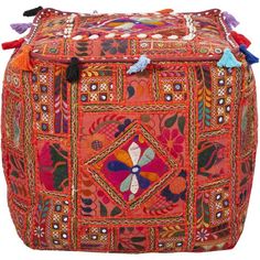 an orange and pink patchwork ottoman with tassels