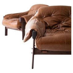 two brown leather reclining chairs sitting next to each other