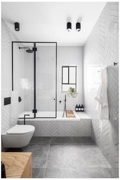 a bathroom with white tile and black accents