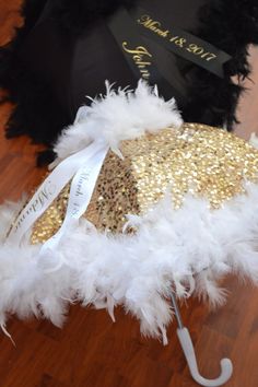 the umbrella is decorated with gold and white feathers