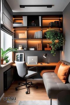 an office with a couch, desk and shelves filled with bookshelves in the corner