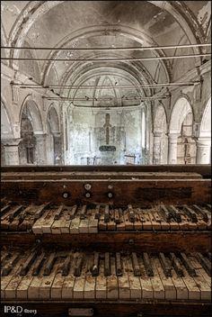 an old piano sitting in front of a window