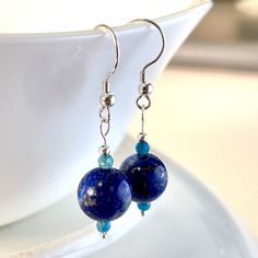 Beautiful and Unique. Handmade Lapis Lazuli with Faceted Apatite gemstone dangle drop earrings.  10mm Lapis Lazuli , 3mm Apatite.  Handmade with Solid Sterling Silver. Earth like.  Lightweight. Comes with meaning cards for each gemstone as seen in pictures. Returns or Exchanges accepted within 30 days of purchase.Feel free to message me with any questions you may have, I'm happy to answer them. Chip Bead Jewelry, Gold Round Earrings, Lapis Jewelry, Gemstone Drop Earrings, Turquoise Crystal, Gemstone Beaded Necklace, With Meaning, Blue Gemstones, Pearl Stud Earrings