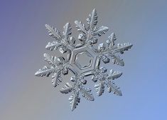 a snowflake is shown against a blue sky