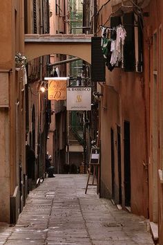 an alley way with clothes hanging on the line