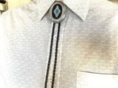 This awesome bolo tie has a southwestern design and real turquoise stone inlay. The cord is genuine leather. Measurements/Sizing Total length of leather is approx. 40 inches1 1/4'' x 2 1/4'' in pendant Turquoise Bolo Tie, Skull Belt Buckle, Cowboy Buckle, Mens Leather Necklace, Cowgirl Gifts, Bison Leather, Silver Gift Wrap, Necklace Leather, Mens Necklace