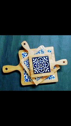 two wooden cutting boards with blue designs on them