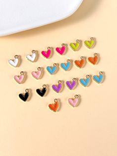 small heart shaped charms sitting on top of a table