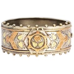 This stunning bangle features silver, yellow gold and rose gold details. The main band is modelled in silver and also has silver plaque overlays. The main plaque has a gorgeous flower priced together with yellow gold and rose gold and wither side of this the bangle is heavily detailed with leaves and engraving. Inner Diameter: 57.5mm Bangle Width: 29mm Yellow Gold Bangle, Vintage Bangles, Victorian Gold, Gold Bracelet Cuff, Gold Cuffs, Gold Bangle Bracelet, Gold Bangle, Fabulous Jewelry, Cuff Bangles