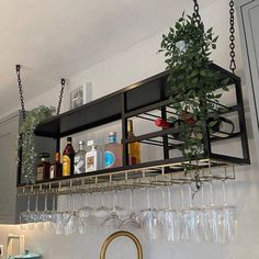 a shelf with wine glasses hanging from it