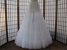 "The pictured petticoat was a custom order for a bride who decided to wear it as the skirt in her wedding outfit instead of as a petticoat -- see last two photos ;) This sale is for a custom version of the pictured white single layer petticoat/skirt made out of soft nylon chiffon. The waist will be .75\" (2cm) wide elastic that will be covered by satin charmeuse for comfort. Sizing is based on HIP circumference, not waist circumference, although I will need your waist measurement also. The hip m Cheap Stretch Tulle Petticoat, Cheap White Crinoline Petticoat, Cheap Spring Petticoat Skirt, Cheap Dance Tulle Petticoat, Cheap Tulle Petticoat For Dance, Cheap White Stretch Petticoat, Cheap Hardwood Floors, Glass Flooring, Tulle Petticoat