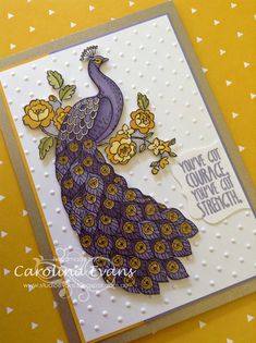 a card with a purple and yellow peacock on it