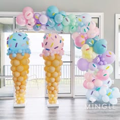 balloons are hanging from the ceiling in front of an open door