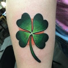 a four leaf clover tattoo on the arm