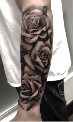 a black and white rose tattoo on the arm